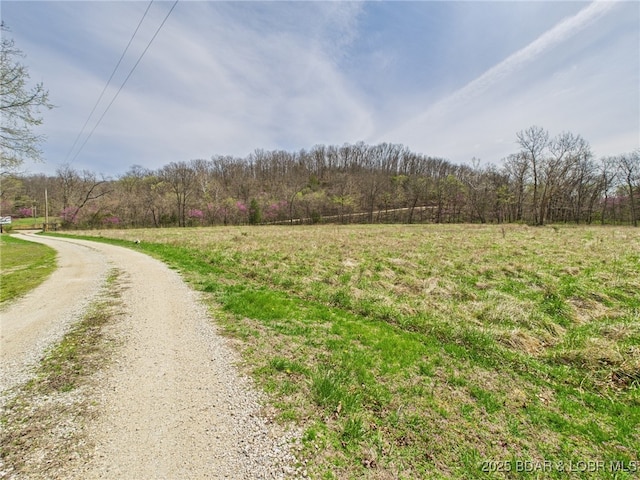 view of road featuring a wooded view