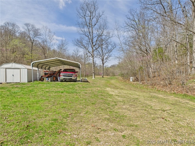 view of yard with an outdoor structure, a shed, and a carport