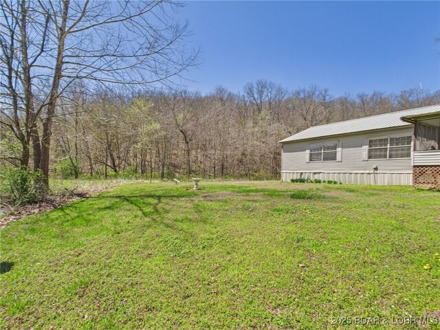 view of yard featuring a view of trees