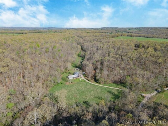 drone / aerial view featuring a forest view