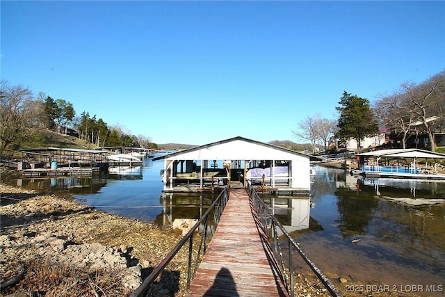 dock area with a water view and boat lift