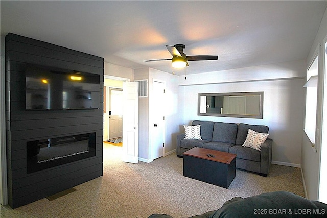 living room featuring ceiling fan, visible vents, baseboards, and carpet