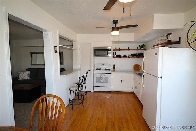 kitchen featuring ceiling fan, white appliances, open shelves, white cabinetry, and wood finished floors