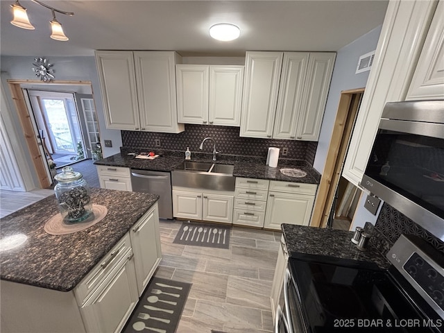 1265 Lick Creek Rd, Edwards, MO 65326 - kitchen featuring stainless steel appliances, white cabinets, decorative backsplash, and dark stone counters