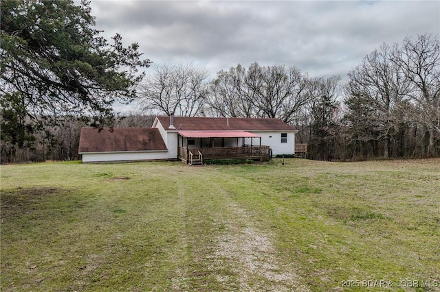 back of property with a lawn