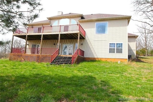 rear view of property featuring a chimney and a lawn