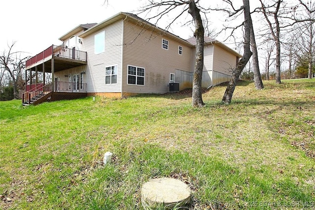 rear view of property with a wooden deck, a lawn, and central air condition unit
