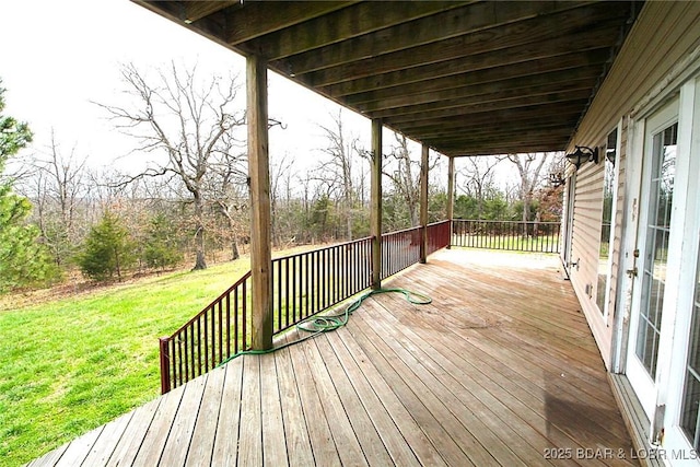 wooden terrace featuring a lawn