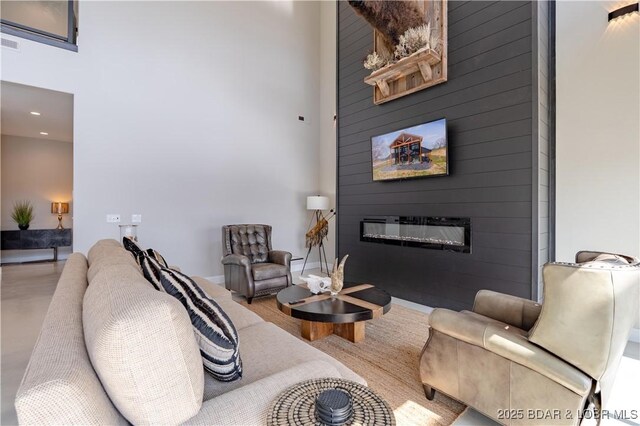 TBD Willow Rd, Eldon, MO 65026 - living room featuring a high ceiling, a large fireplace, and recessed lighting