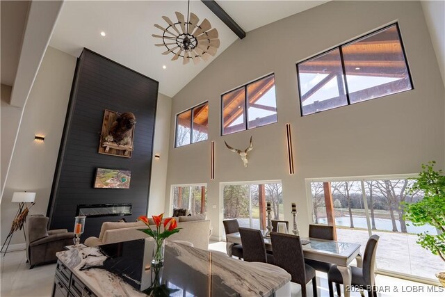 TBD Willow Rd, Eldon, MO 65026 - dining area with high vaulted ceiling, a water view, a large fireplace, a chandelier, and beamed ceiling