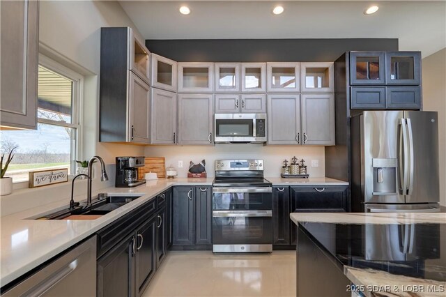 TBD Willow Rd, Eldon, MO 65026 - kitchen with stainless steel appliances, light countertops, recessed lighting, and glass insert cabinets