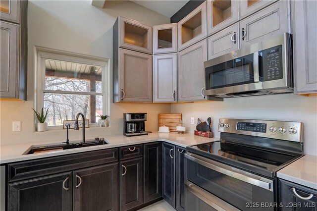 TBD Willow Rd, Eldon, MO 65026 - kitchen with stainless steel appliances, light countertops, and glass insert cabinets