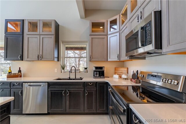 TBD Willow Rd, Eldon, MO 65026 - kitchen featuring appliances with stainless steel finishes, light countertops, and glass insert cabinets