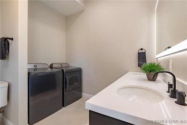 TBD Willow Rd, Eldon, MO 65026 - bathroom with independent washer and dryer and double vanity