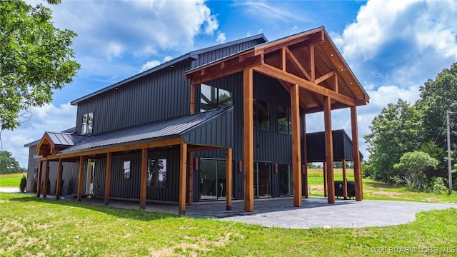 TBD Willow Rd, Eldon, MO 65026 - back of house featuring board and batten siding, a yard, and a metal roof
