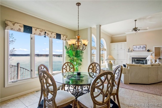 1065 Imperial Point Dr, Four Seasons, MO 65049 - dining room with healthy amount of natural light, light tile patterned floors, ornamental molding, a chandelier, and a water view