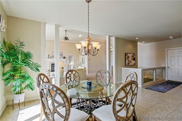 1065 Imperial Point Dr, Four Seasons, MO 65049 - dining space featuring a chandelier, recessed lighting, light tile patterned flooring, ornate columns, and a glass covered fireplace