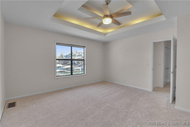 1293 Ginger Rd, Lake Ozark, MO 65049 - unfurnished bedroom with baseboards, a raised ceiling, visible vents, and light colored carpet