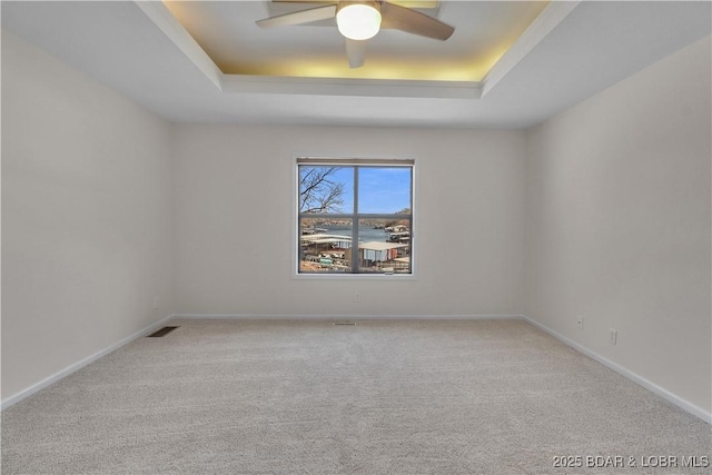 1293 Ginger Rd, Lake Ozark, MO 65049 - carpeted empty room with a ceiling fan, visible vents, baseboards, and a raised ceiling