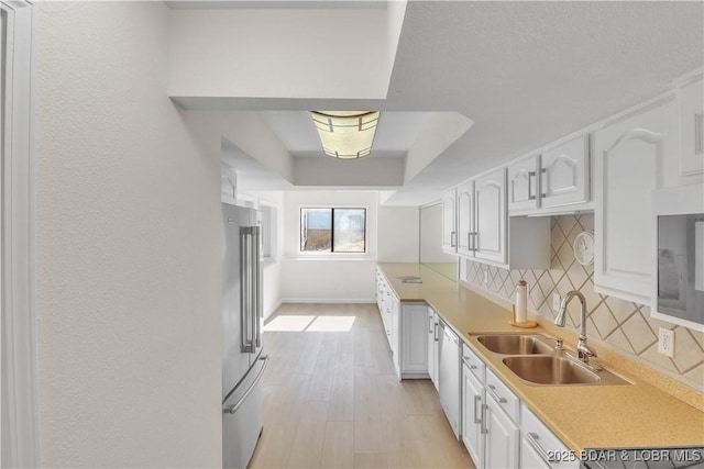 1293 Ginger Rd, Lake Ozark, MO 65049 - kitchen featuring high quality fridge, a sink, white cabinetry, dishwashing machine, and backsplash
