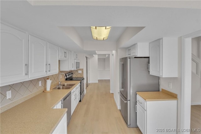 1293 Ginger Rd, Lake Ozark, MO 65049 - kitchen with stainless steel appliances, light countertops, and white cabinets