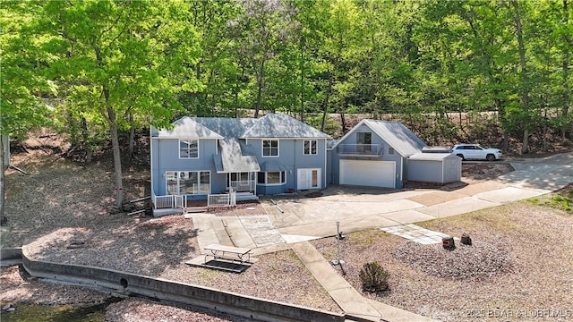 1293 Ginger Rd, Lake Ozark, MO 65049 - colonial home with concrete driveway, a porch, and a garage
