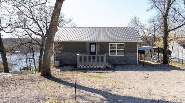 1636 Carol Rd, Lake Ozark, MO 65049 - view of front of property featuring a detached carport, metal roof, brick siding, and central air condition unit