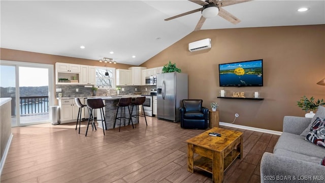 1636 Carol Rd, Lake Ozark, MO 65049 - living area featuring a wall mounted AC, wood finished floors, ceiling fan, recessed lighting, and high vaulted ceiling