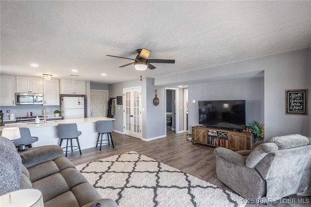 2500 Bay Point Ln Unit 135, Osage Beach, MO 65065 - living room with baseboards, recessed lighting, a textured ceiling, a ceiling fan, and wood finished floors
