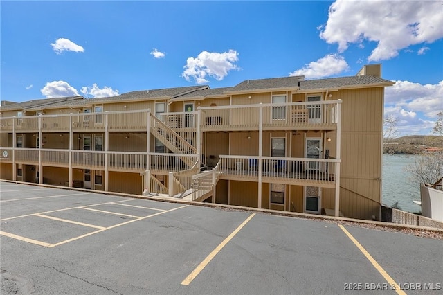 2500 Bay Point Ln Unit 135, Osage Beach, MO 65065 - view of building exterior featuring uncovered parking and stairs
