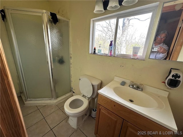 bathroom featuring a shower stall, tile patterned floors, vanity, and toilet