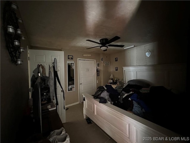 bedroom with ceiling fan and light tile patterned floors