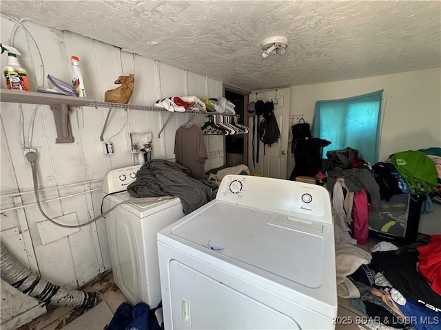 clothes washing area featuring laundry area and washing machine and clothes dryer