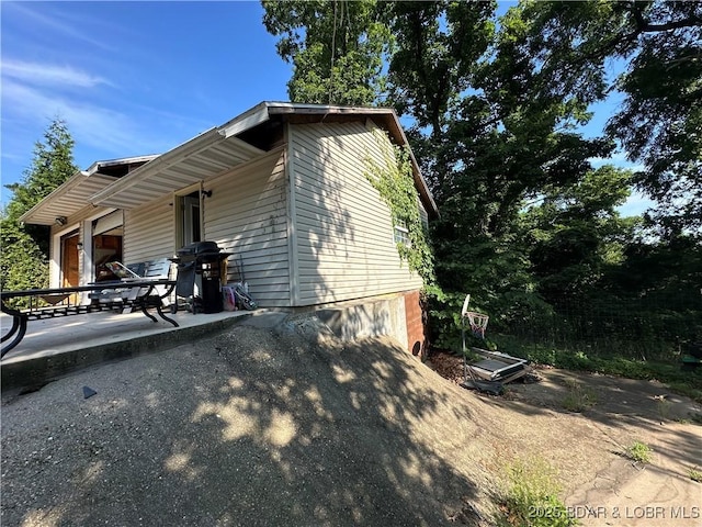 24431 Scenic Ridge Rd, Barnett, MO 65011 - view of home's exterior with a patio area and driveway