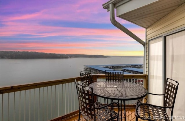 1481 Ledges Dr Unit 1046, Osage Beach, MO 65065 - balcony at dusk featuring a water view and outdoor dining area