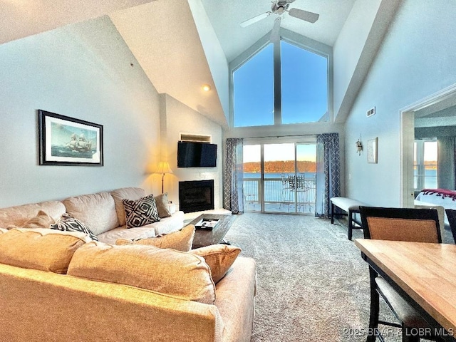 1481 Ledges Dr Unit 1046, Osage Beach, MO 65065 - carpeted living area with visible vents, a fireplace, a ceiling fan, and high vaulted ceiling