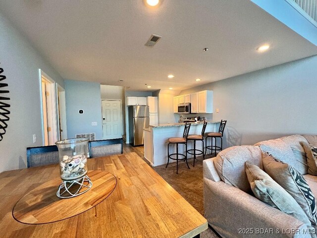 1481 Ledges Dr Unit 1046, Osage Beach, MO 65065 - living area featuring light wood finished floors, visible vents, and recessed lighting