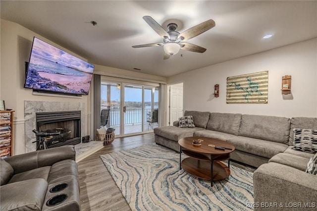 251 Vision Dr Unit 1D, Camdenton, MO 65020 - living room with wood finished floors, ceiling fan, and a high end fireplace