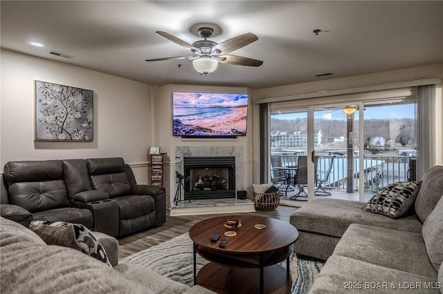 251 Vision Dr Unit 1D, Camdenton, MO 65020 - living area with visible vents, ceiling fan, a premium fireplace, and wood finished floors