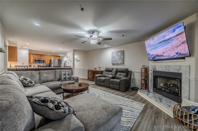 251 Vision Dr Unit 1D, Camdenton, MO 65020 - living area featuring baseboards, recessed lighting, wood finished floors, ceiling fan, and a premium fireplace