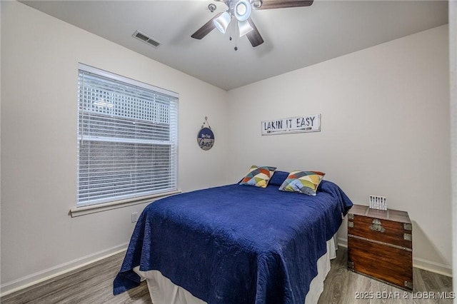 251 Vision Dr Unit 1D, Camdenton, MO 65020 - bedroom featuring visible vents, baseboards, ceiling fan, and wood finished floors