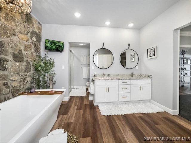 16 Hawk Hill Ct, Lake Ozark, MO 65049 - full bath with a stall shower, double vanity, wood finished floors, a soaking tub, and recessed lighting