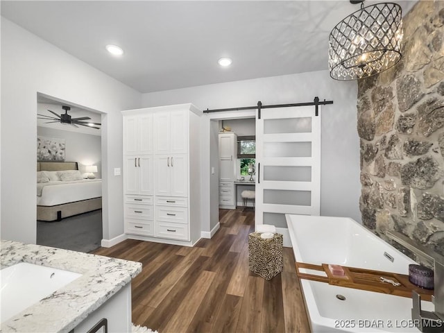 16 Hawk Hill Ct, Lake Ozark, MO 65049 - full bathroom with a soaking tub, ceiling fan, vanity, wood finished floors, and connected bathroom