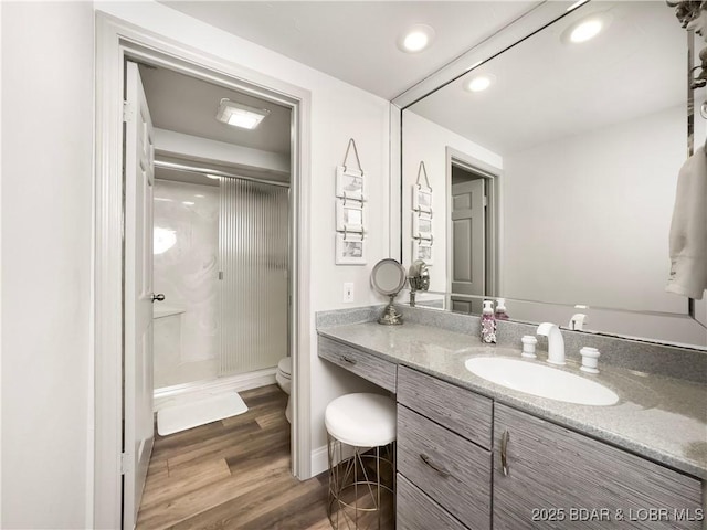 16 Hawk Hill Ct, Lake Ozark, MO 65049 - bathroom with toilet, vanity, a shower stall, recessed lighting, and wood finished floors