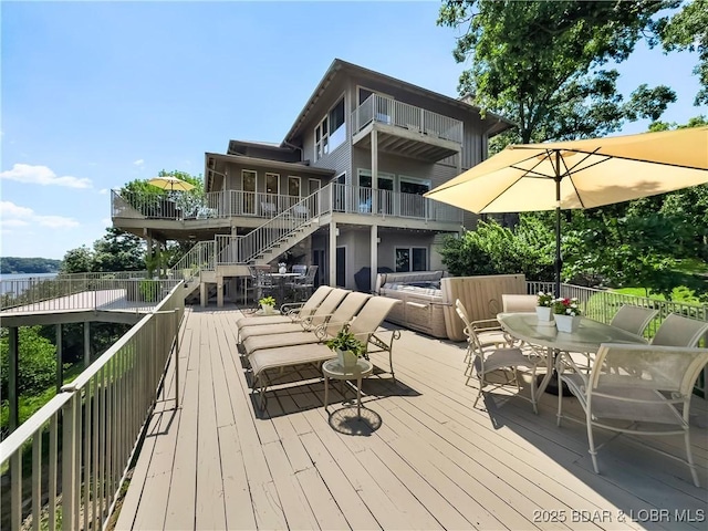 16 Hawk Hill Ct, Lake Ozark, MO 65049 - deck featuring stairs, an outdoor hangout area, and outdoor dining space