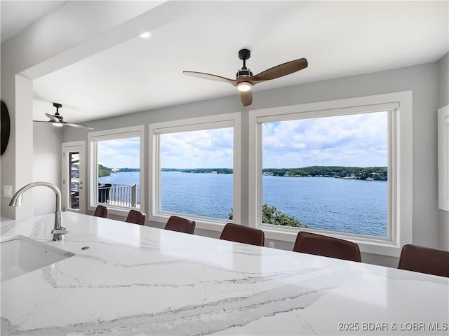 16 Hawk Hill Ct, Lake Ozark, MO 65049 - dining space featuring a ceiling fan, healthy amount of natural light, and a water view