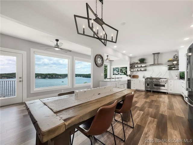 16 Hawk Hill Ct, Lake Ozark, MO 65049 - dining room with dark wood-type flooring, a ceiling fan, recessed lighting, and a water view