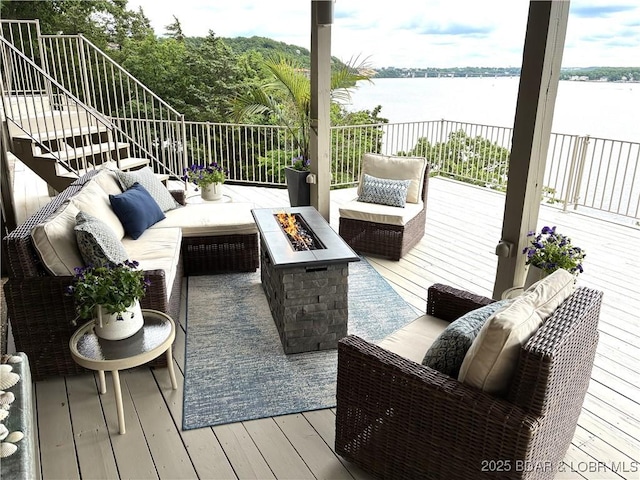16 Hawk Hill Ct, Lake Ozark, MO 65049 - deck featuring stairs, an outdoor living space with a fire pit, and a water view