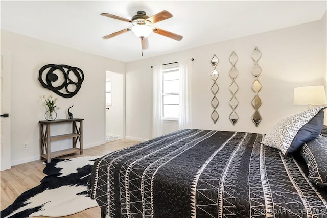 83 Archer Dr, Camdenton, MO 65020 - bedroom with wood finished floors, baseboards, and a ceiling fan