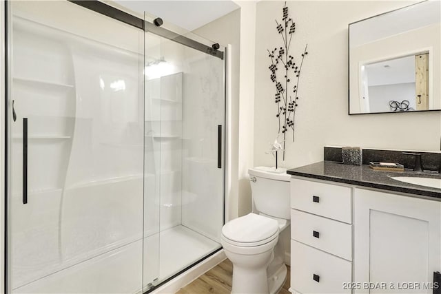 83 Archer Dr, Camdenton, MO 65020 - full bathroom with toilet, wood finished floors, vanity, and a stall shower